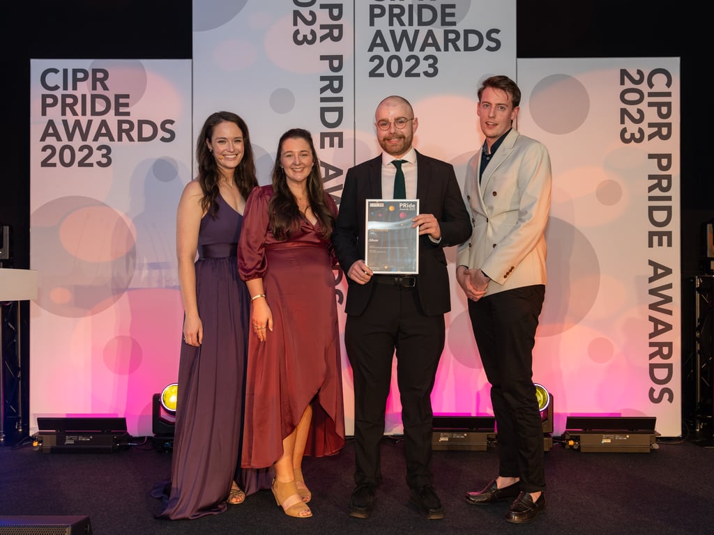 Account Manager Fergus Robb at award winning PR agency Holyrood PR on stage to collect a silver award at the 2023 CIPR Scotland PRide awards for Young Communicator of the Year.