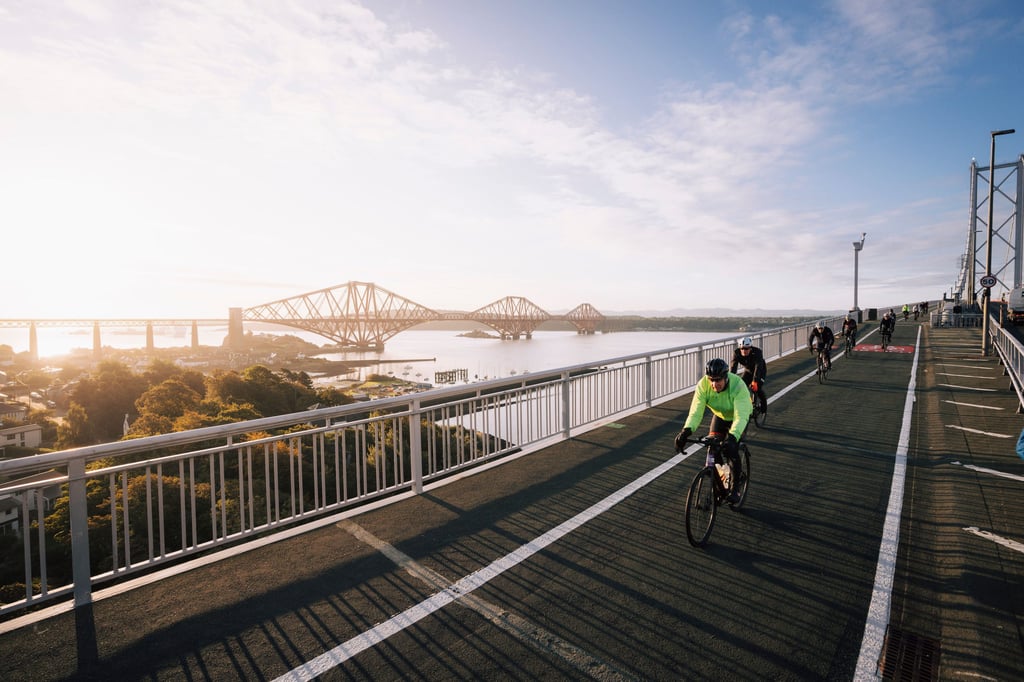 Cyclists competing in the Ride Across Britain, supported by Water Direct, crossing the Forth bridges | Scottish PR