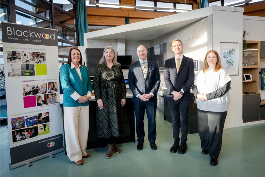 Social Care PR Photography of Neil Gray MSP, Cabinet Secretary for Health and Social Care, standing with staff at the Peoplehood Project