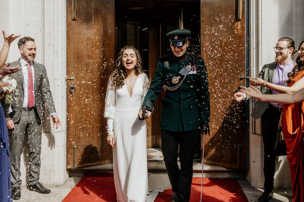 A bride and groom exiting wedding ceremony at Surgeons Hall