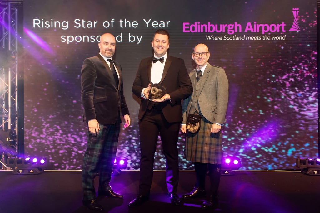 Hospitality PR Photography of Martijn Zengerink, General Manager standing with Rising Star of the Year Award and two men at ceremony