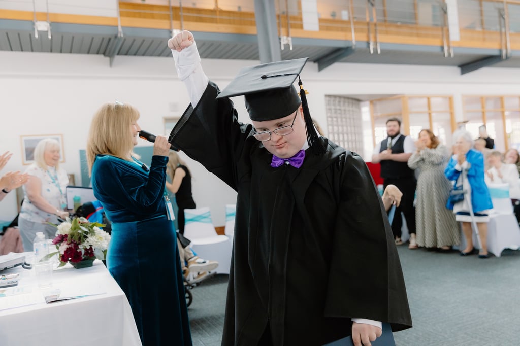 Student Darren Fitzpatrick celebrates graduating at Corseford College's first ever graduation ceremony, as showcased by Charity PR.