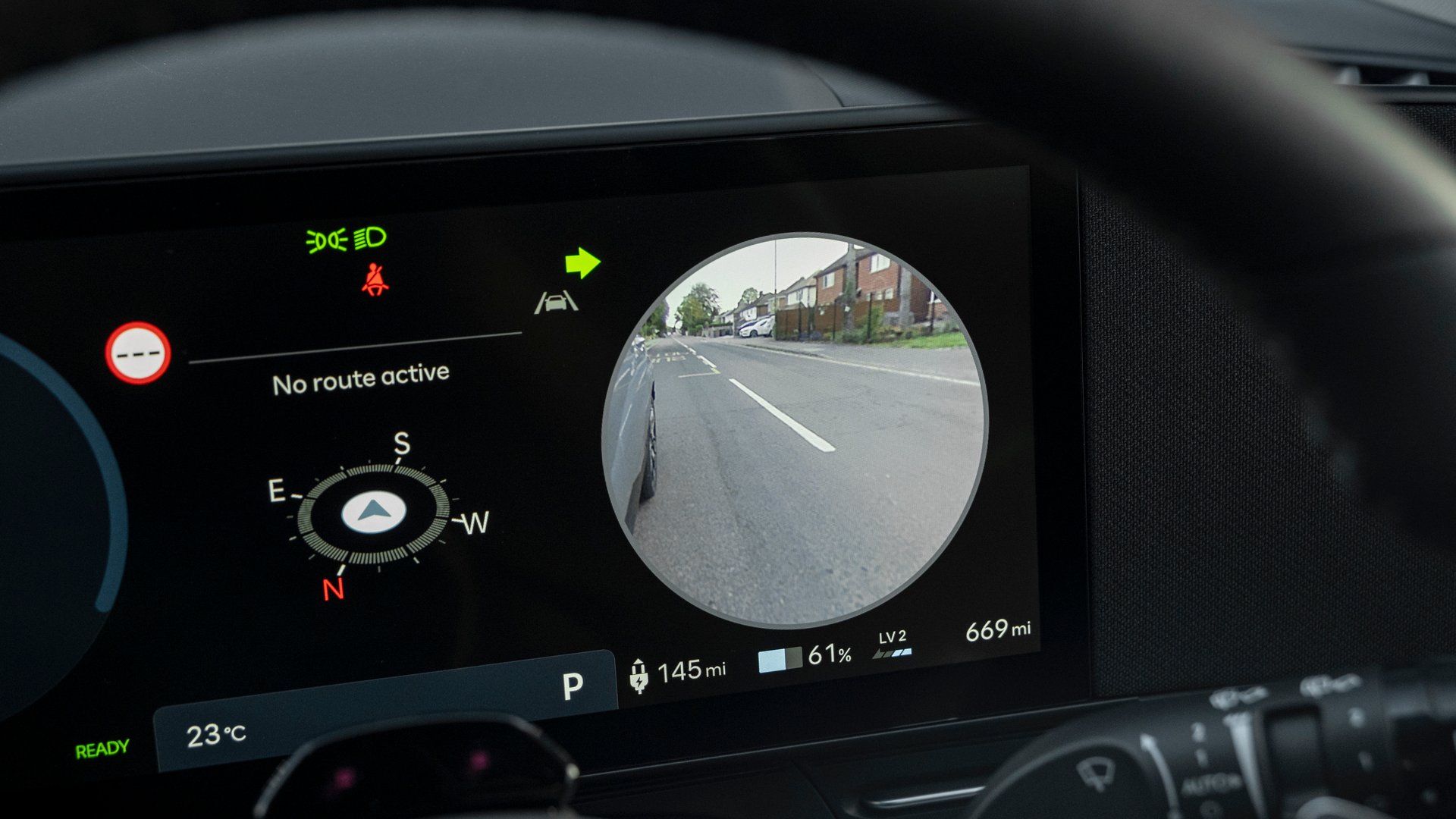 Hyundai Kona Electric’s digital driver display showcasing the blind-spot monitoring system in action, enhancing safety with a clear visual of the vehicle’s surroundings