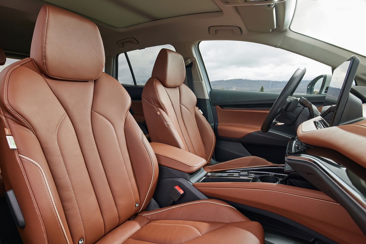 Spacious seating inside the Skoda Enyaq with elegant brown leather upholstery, offering both style and comfort for passengers.