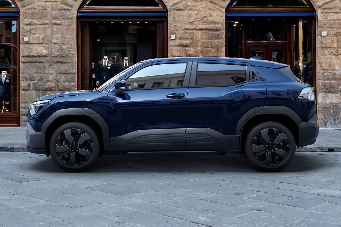 Suzuki E-Vitara electric SUV in urban setting.