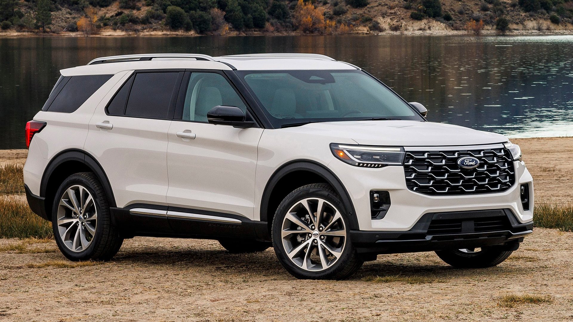 The refined Ford Explorer SUV in a classic white finish, parked by a tranquil lakeside setting for the 2025 lineup.