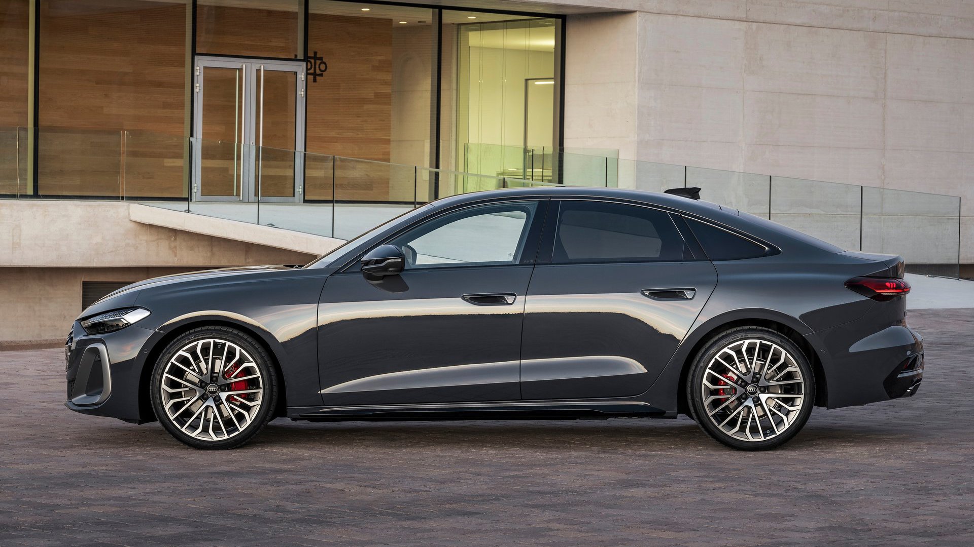 The 2025 Audi A5 in a side profile, displaying its sophisticated silhouette against a minimalist backdrop.