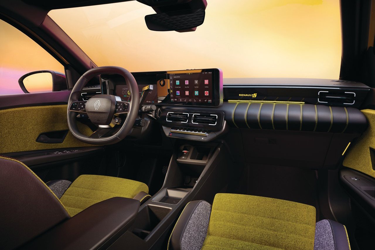 Interior view of the Renault 5, highlighting its high-tech dashboard, digital display, and vibrant upholstery with green accents.