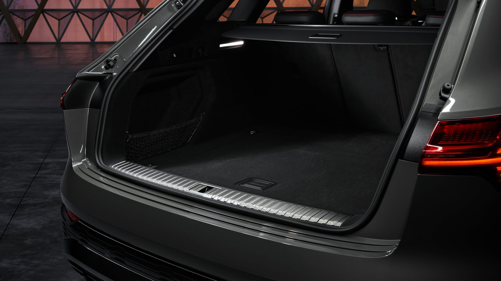 Spacious boot of the Audi Q8 E-Tron with foldable rear seats, highlighting the SUV's practical storage capacity for family and travel needs.