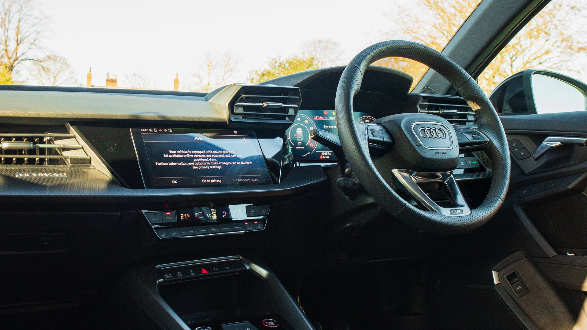 The interior of the Audi RS3, featuring a modern cockpit with a digital dashboard, flat-bottom steering wheel, and advanced touchscreen controls.