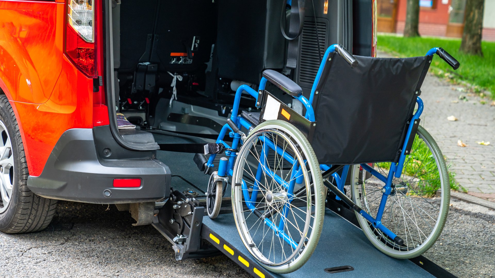 Accessible vehicle with a ramp extended for a manual wheelchair, showcasing a mobility solution for people with disabilities.