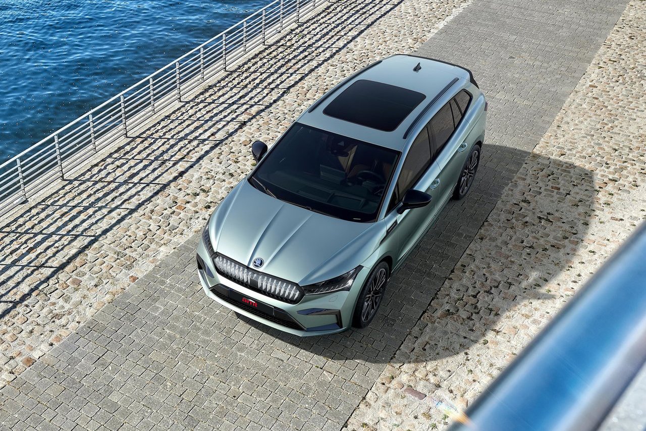 A stunning aerial view of the Skoda Enyaq electric SUV parked by the water, highlighting its sleek design and performance-driven engineering.