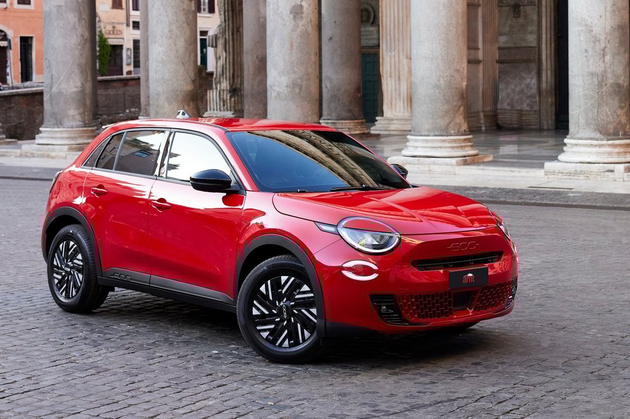 A bold red Fiat 600e parked against a classic Roman backdrop, showcasing the compact SUV's 2025 modern electric design.