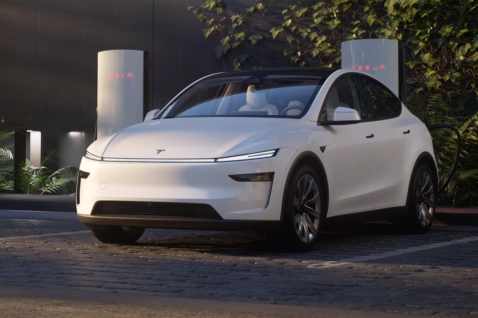 The 2025 Tesla Model Y Facelift charging at a Tesla Supercharger station, highlighting its enhanced efficiency and range.