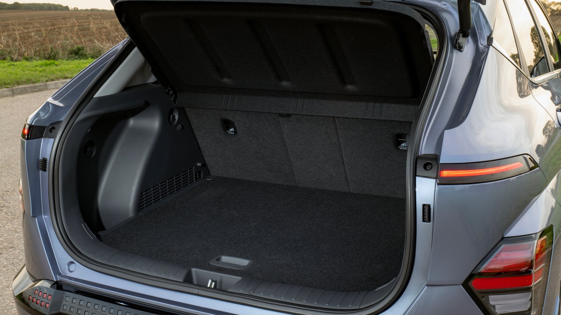 Open boot of the Hyundai Kona Electric, highlighting its spacious and practical design, ideal for daily errands, weekend getaways, and accommodating bulkier items with ease