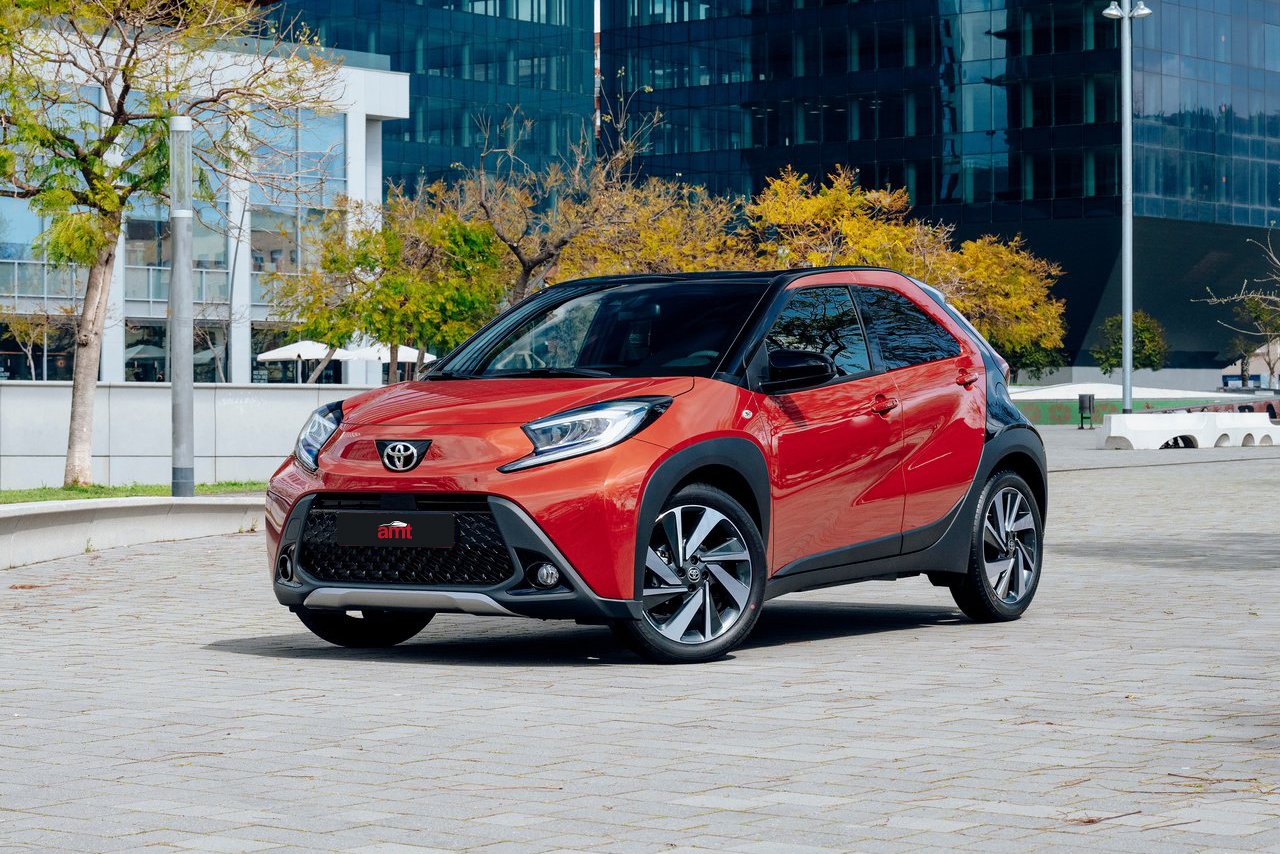 The stylish Toyota Aygo X in vibrant red, displayed in a contemporary urban setting, perfect for the 2025 city lifestyle.