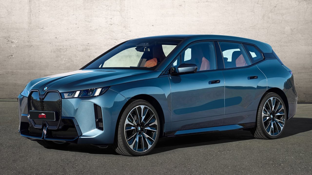 The 2025 BMW iX showing its futuristic front design with a prominent kidney grille and sleek lines.