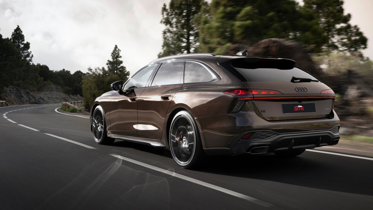 The Audi A6 Avant from a rear perspective, driving through scenic winding roads, illustrating its practicality, comfort, and dynamic performance.