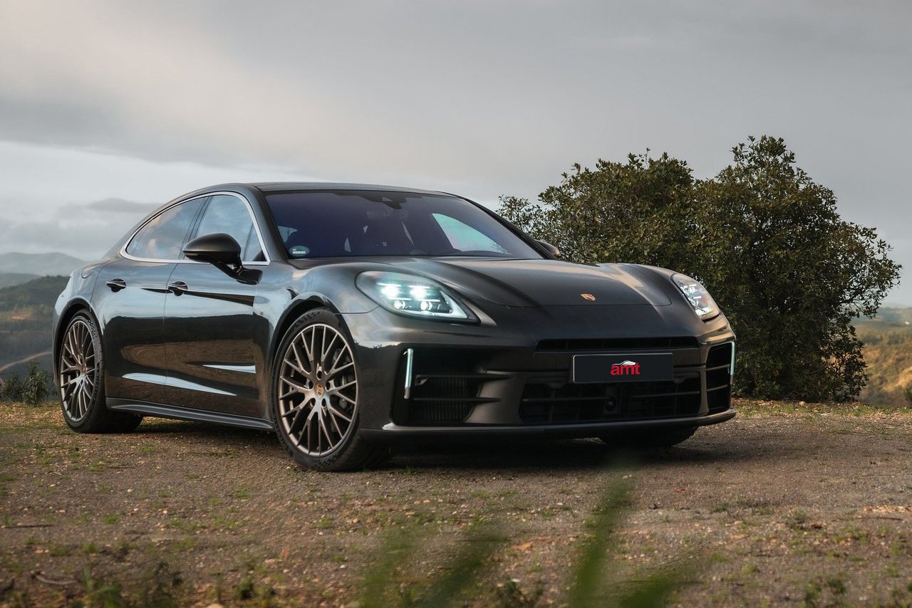 The sleek black Porsche Panamera set against a misty countryside, showcasing high-performance luxury for 2025.