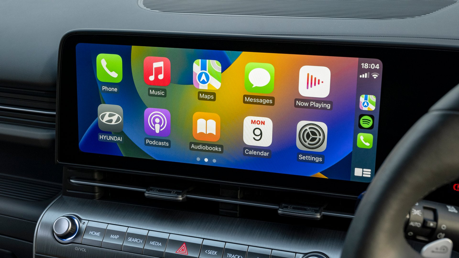 Close-up of the Hyundai Kona Electric’s 12.3-inch touchscreen display, showcasing seamless smartphone integration through Apple CarPlay, highlighting its advanced technology and user-friendly interface.