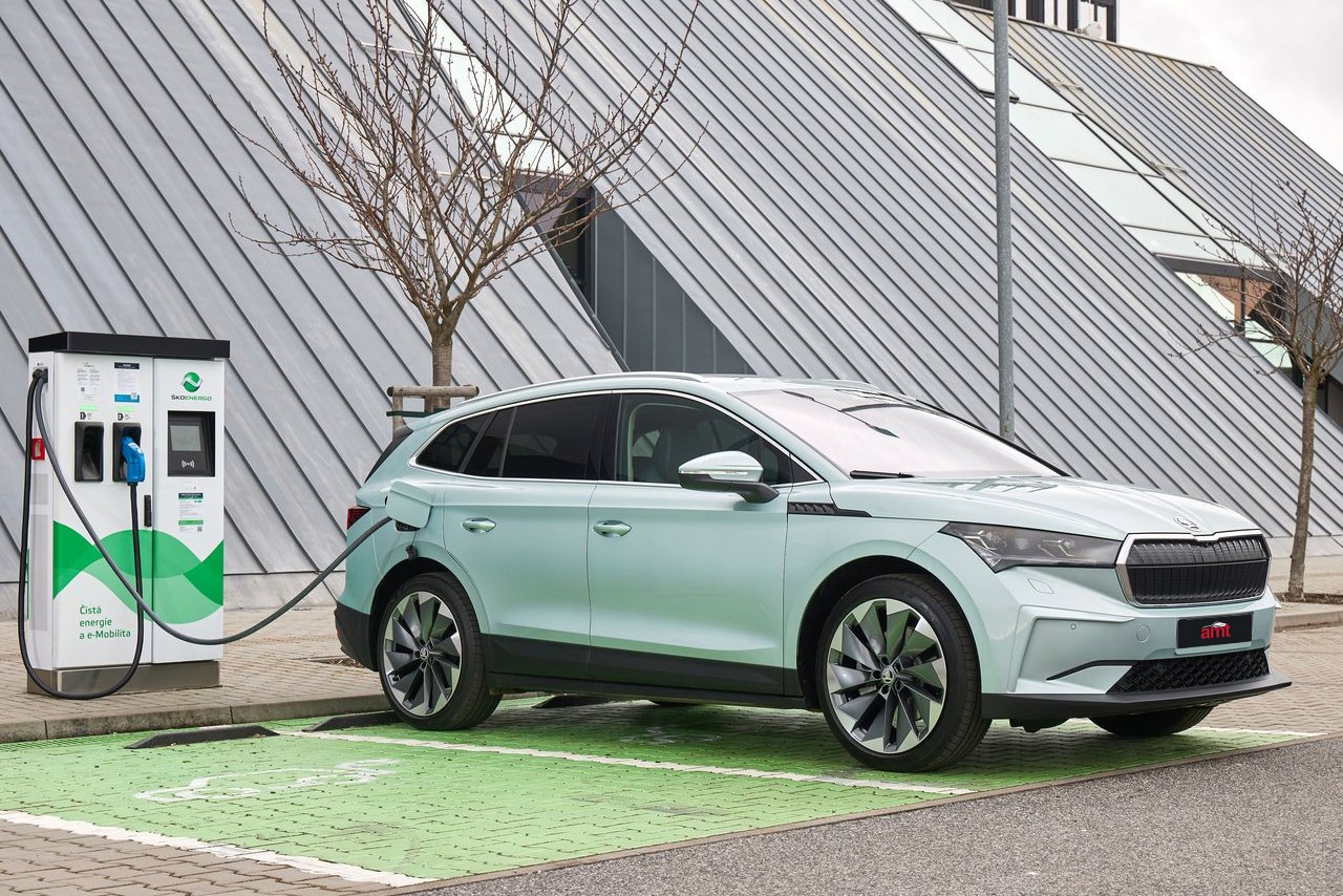 The Skoda Enyaq electric SUV charging at a public charging station, showcasing eco-friendly mobility and advanced charging capabilities.