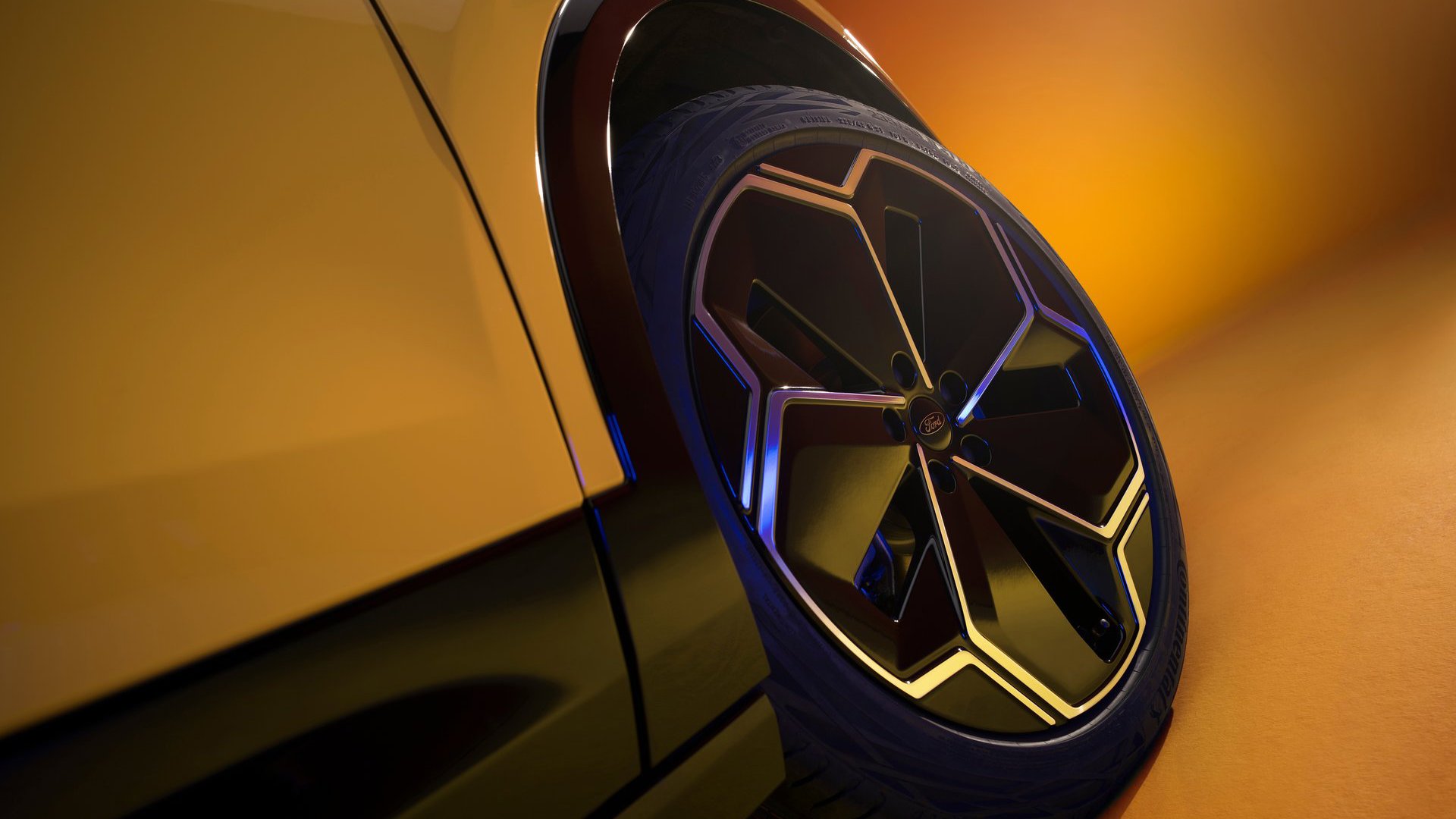 Close-up of the Ford Capri's alloy wheel design, showcasing its intricate geometry and sporty elegance in a studio-lit environment.