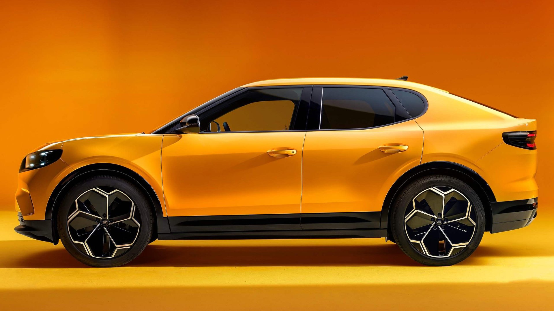 Side profile of the yellow Ford Capri in a studio setting, emphasising its smooth curves, dynamic lines, and sporty stance.
