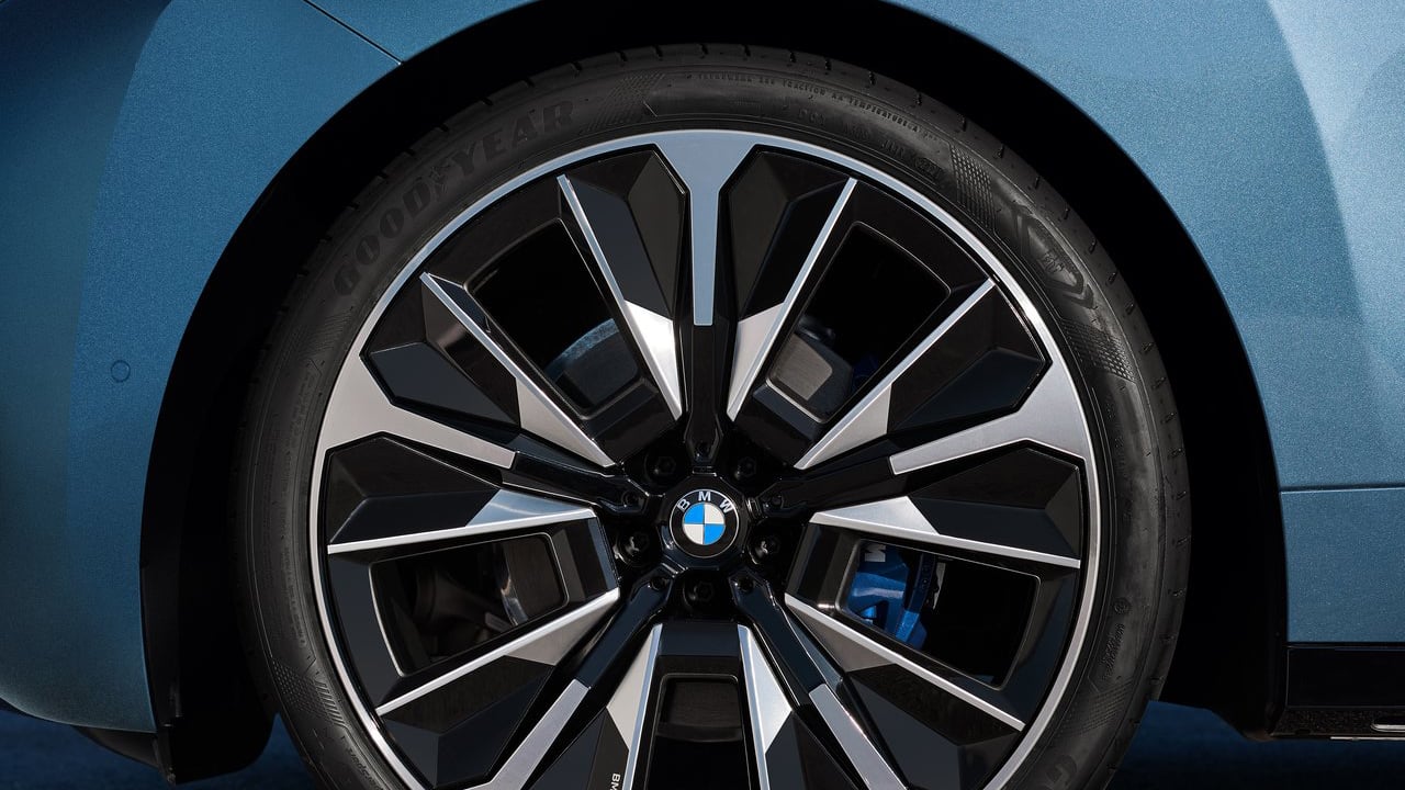 Close-up of the 2025 BMW iX's stylish, multi-spoke alloy wheel with black and chrome accents.