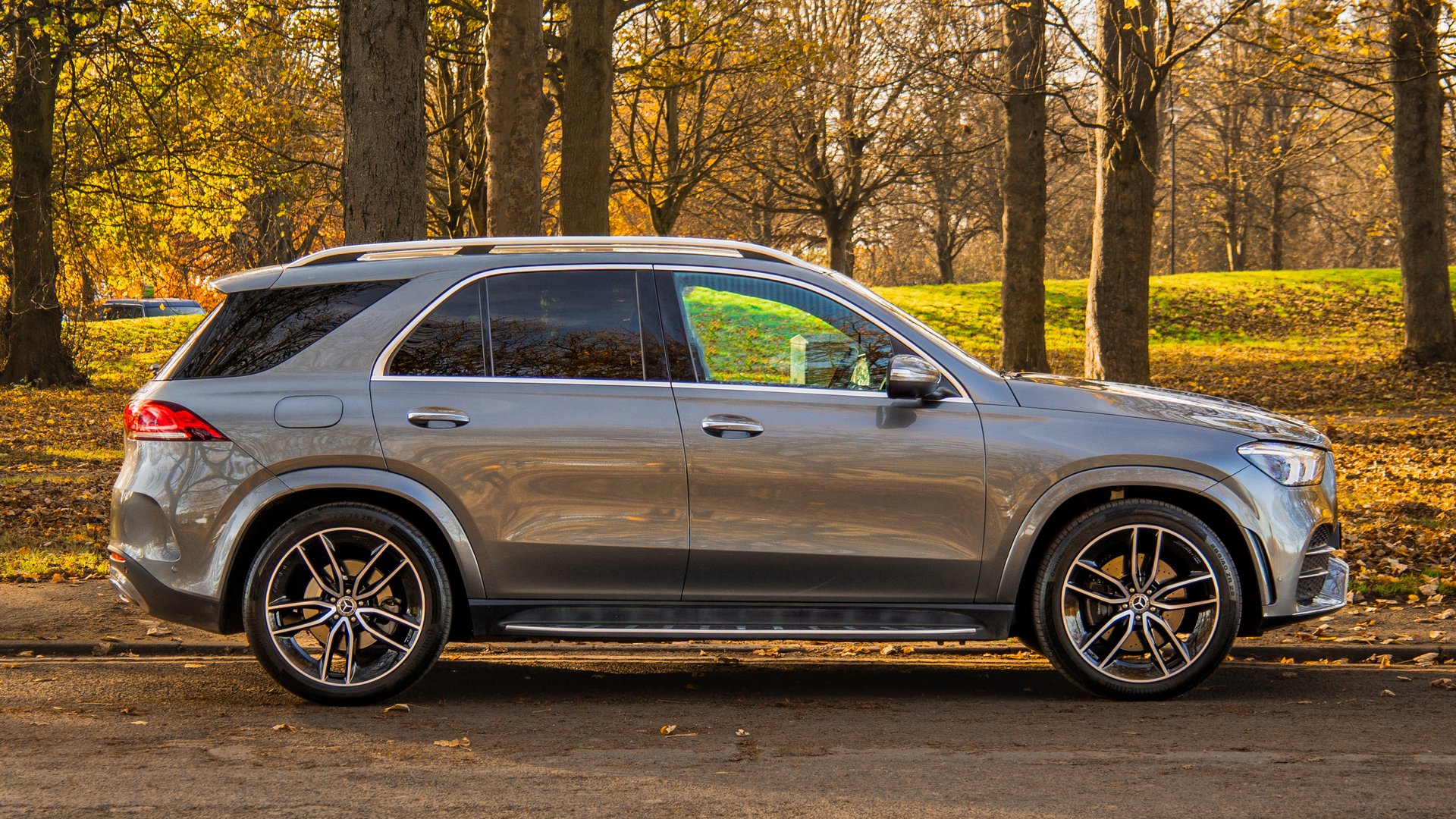 Side profile of the Mercedes-Benz GLE, highlighting its stylish exterior and streamlined bodywork against an autumn landscape, ideal for a comprehensive Mercedes-Benz GLE review.
