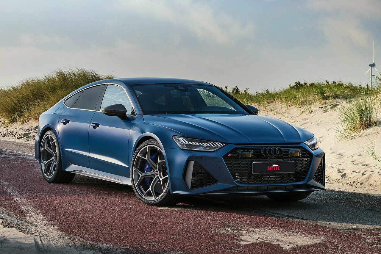 A striking blue Audi RS7 Sportback parked on a scenic coastal road, blending performance and elegance in 2025.