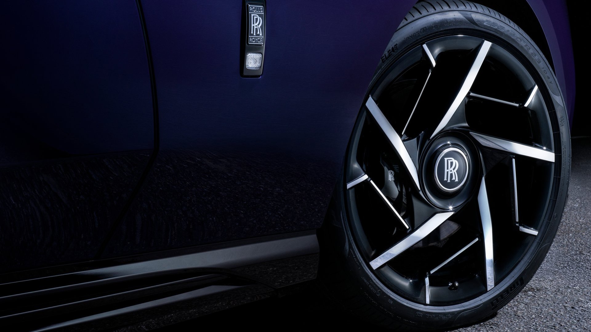 A close-up of the Rolls-Royce Spectre Black Badge's custom wheels and brake callipers, highlighting the premium craftsmanship and performance-focused design.