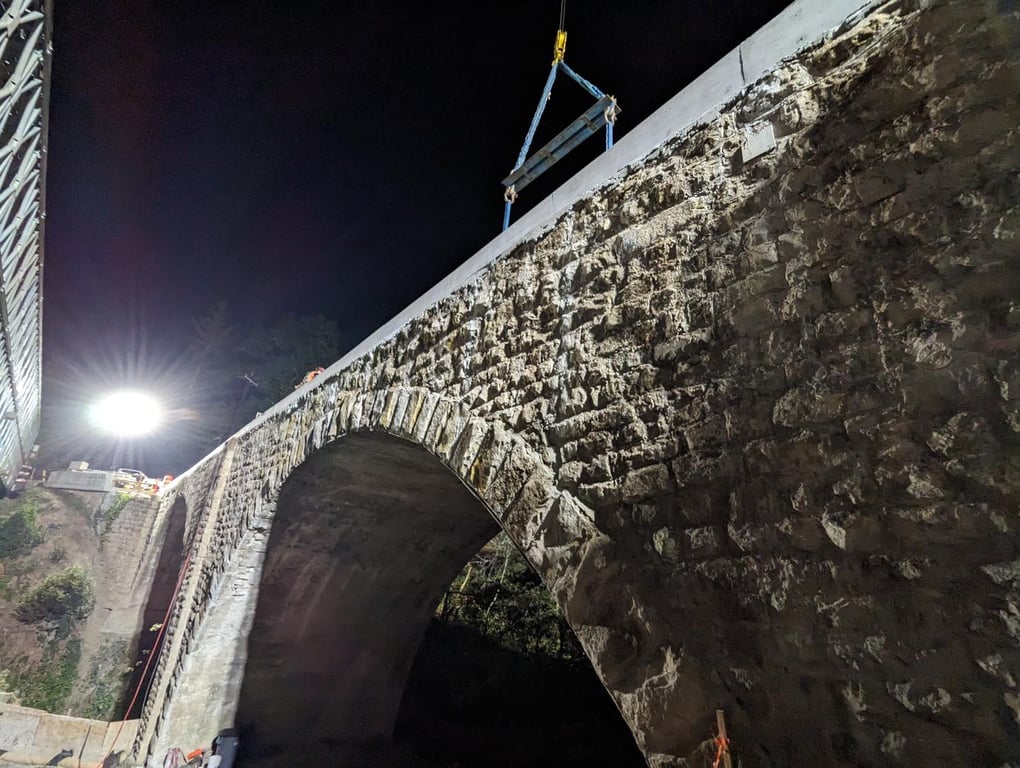 Historic stone arch bridge at night
