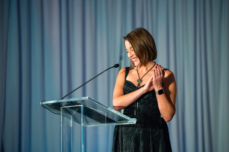 Ucross-Gala-Ucross-President-and-Executive-Director-Caitlin-Addlesperger-applauds-guests-2048x1363