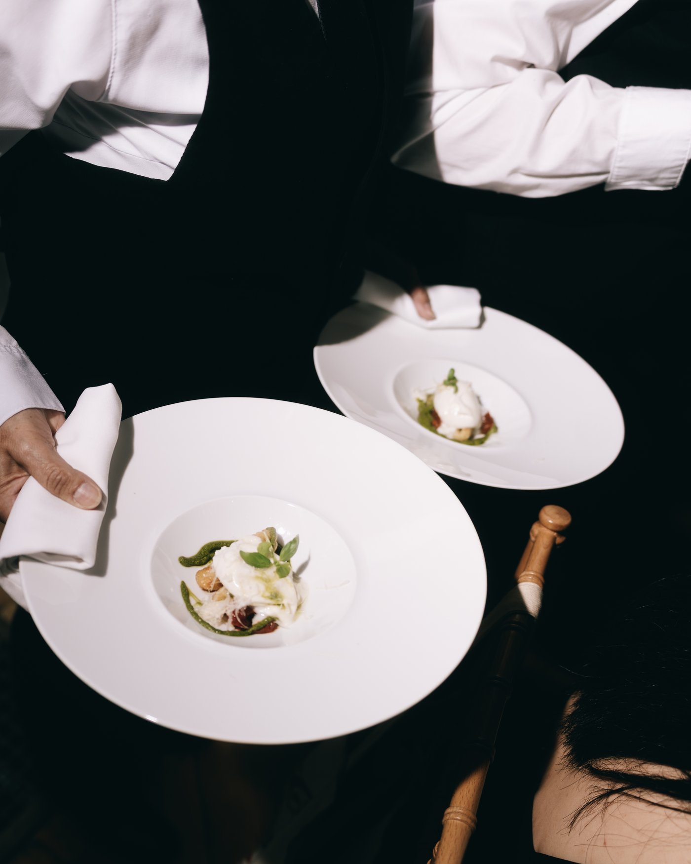 Two plated courses coming out of the kitchen