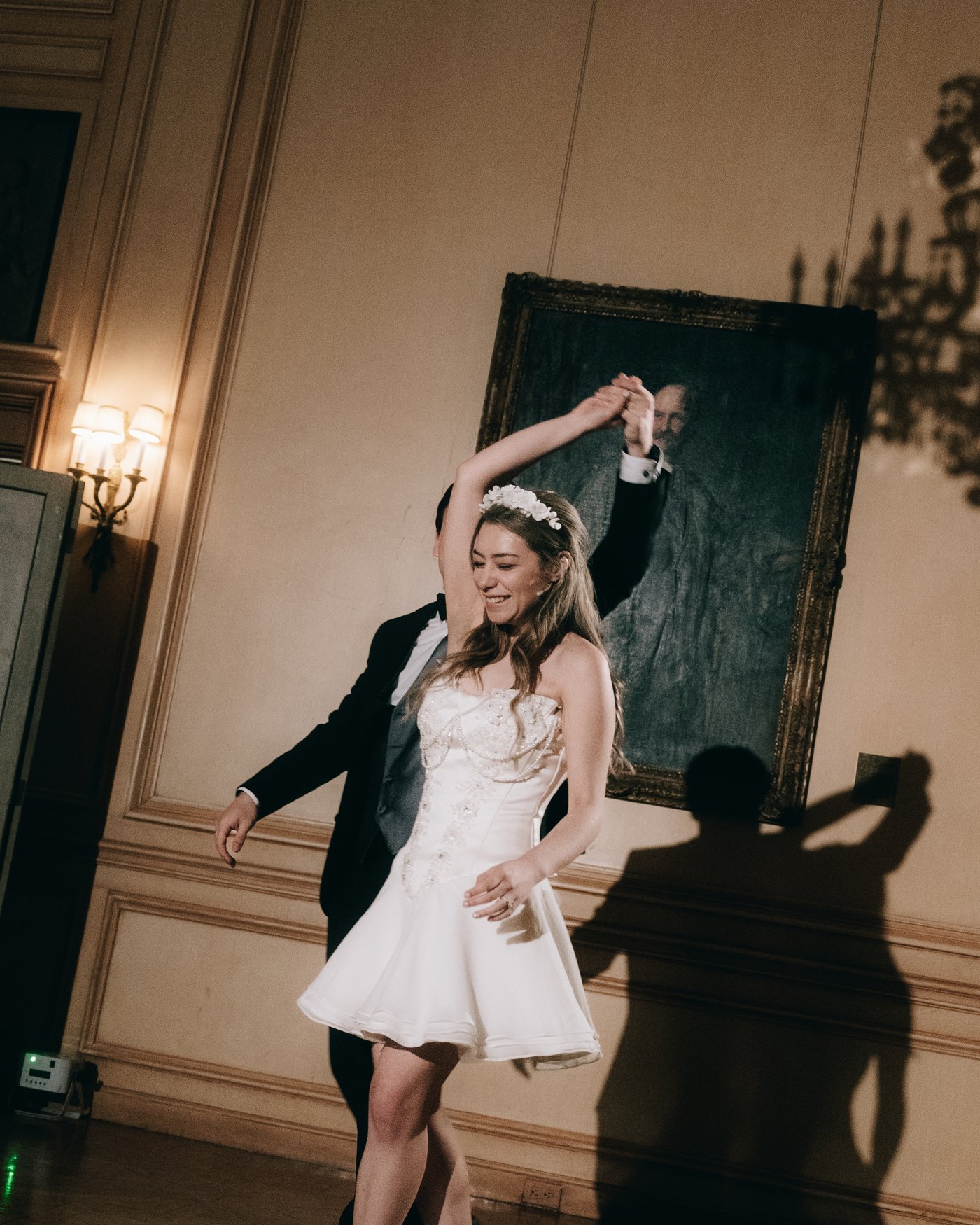 The bride dancing with her arms above her head