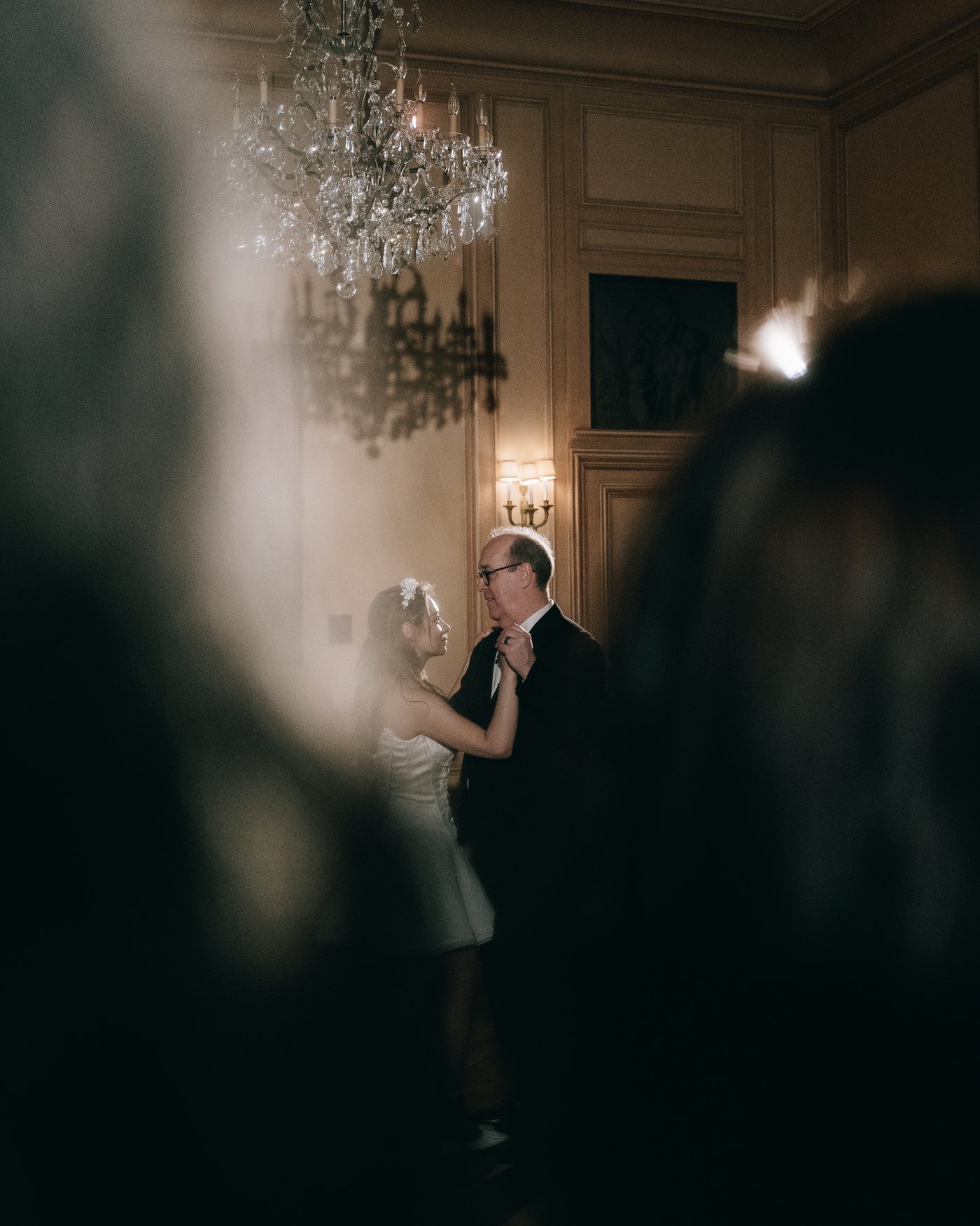 A guest through the blur of a chandelier