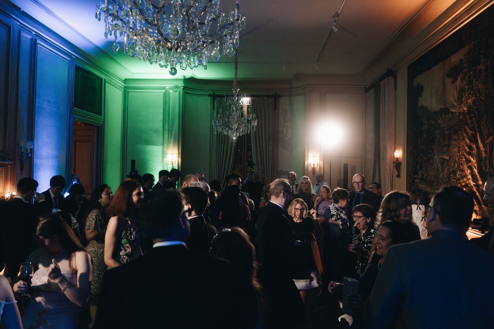 The dance floor washed in green and blue light, the room full