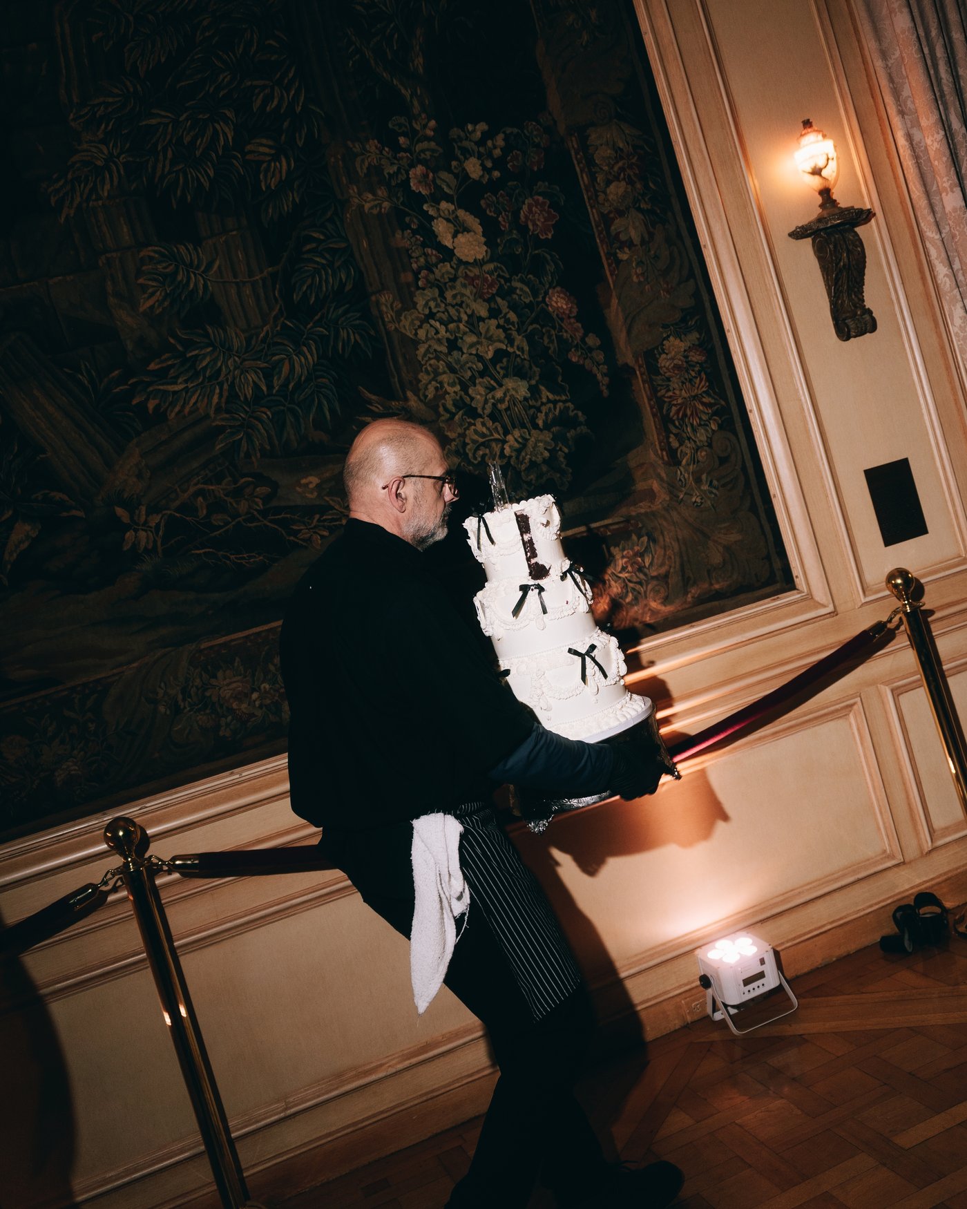 A guest holding up the cake sign for the room