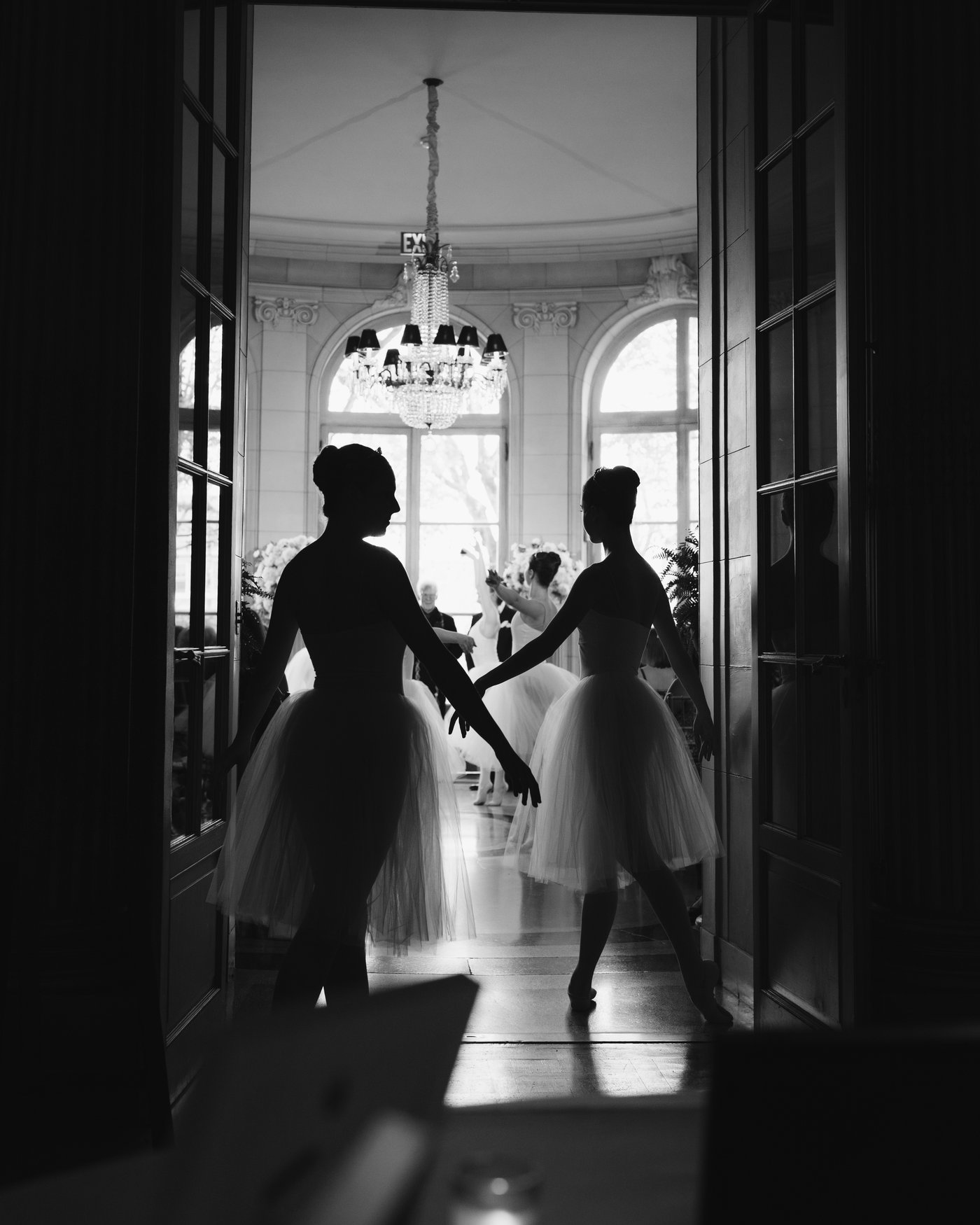 The couple in a bright doorway, seen from the dark room beyond