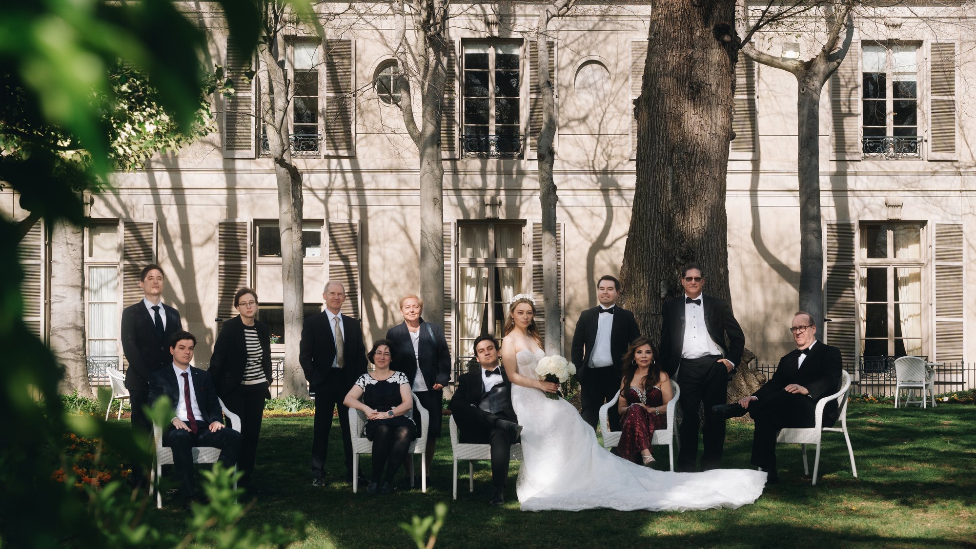 The ceremony on the lawn, guests seated in rows in front of the house