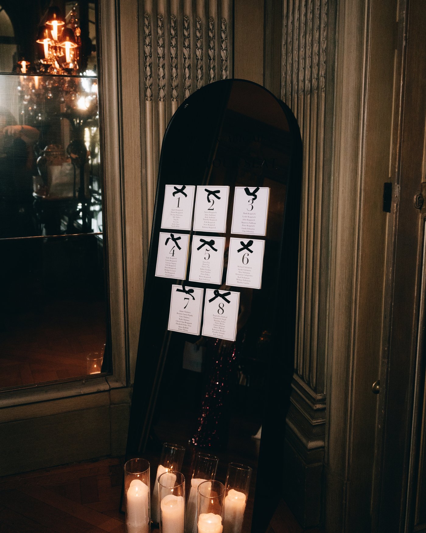 The seating chart standing between two banks of candles