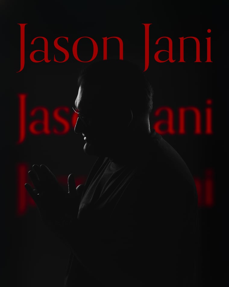 A man in profile in near darkness, his name lettered in red and repeated down the backdrop behind him
