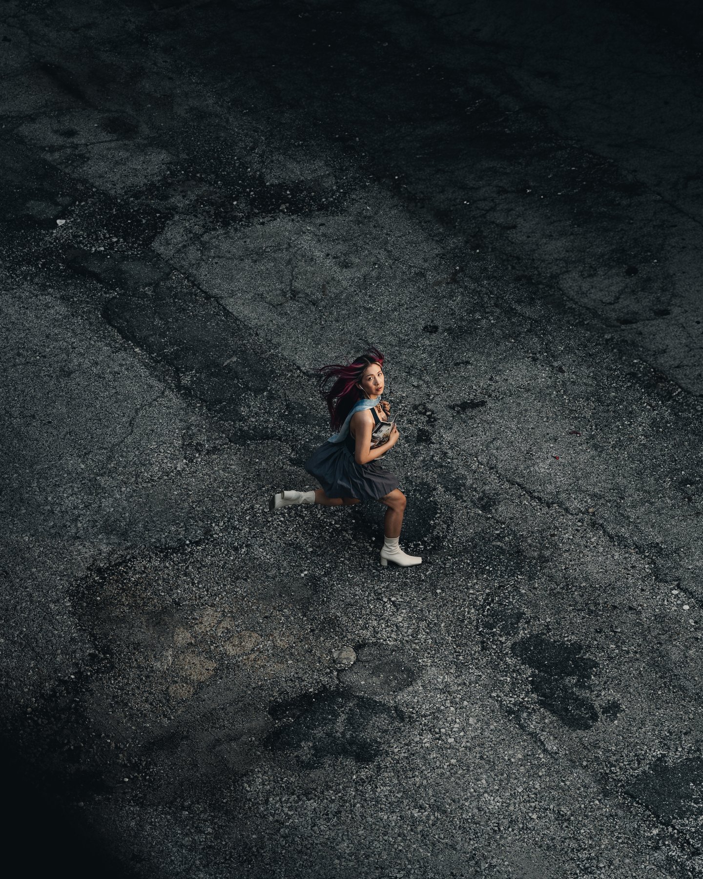 Overhead of the same lot, the figure small against the dark ground