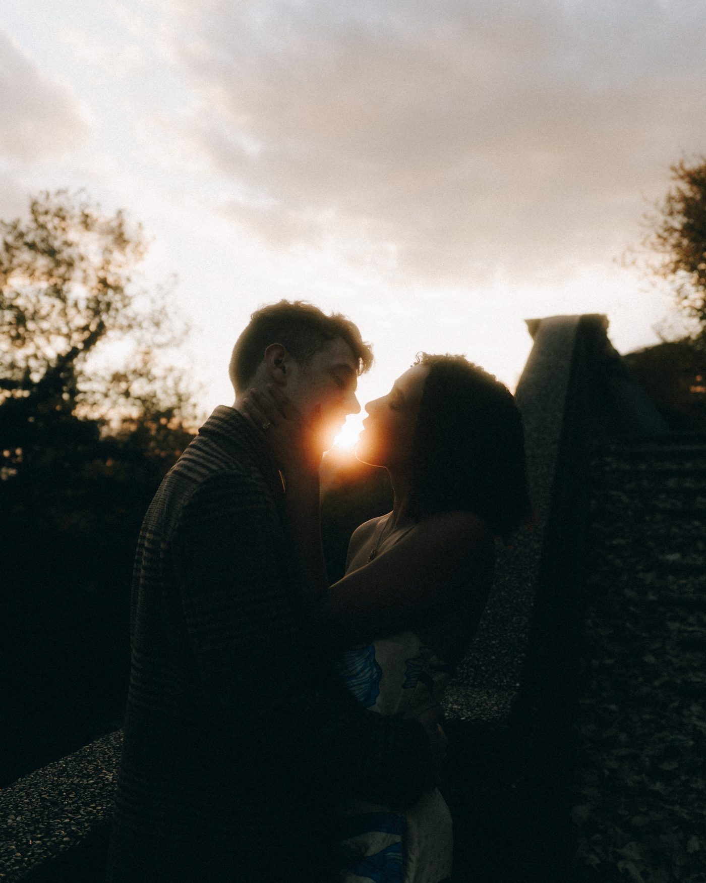 Nose to nose at sunset, the sun burning through the narrow gap between their faces