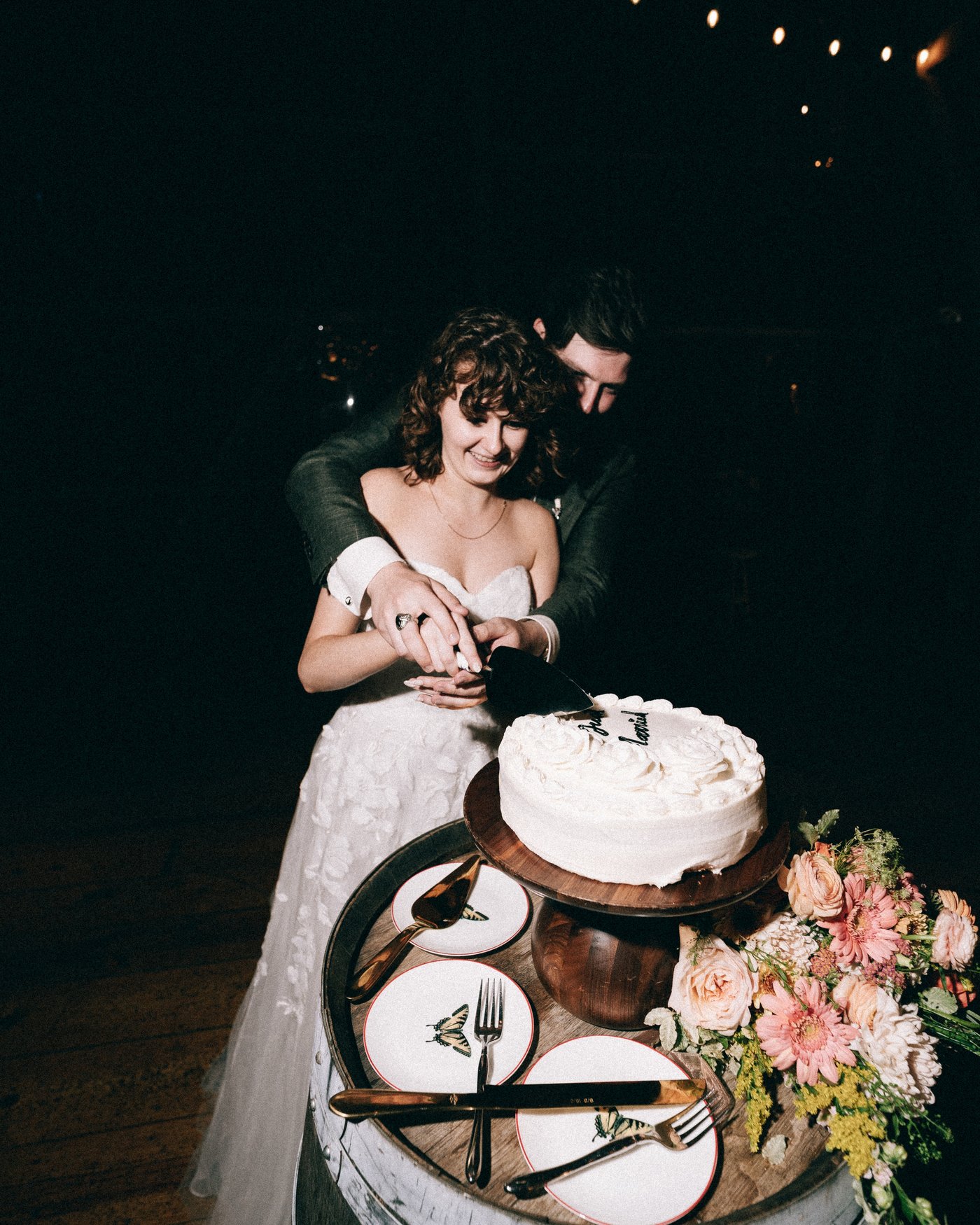The bride standing at the cake table