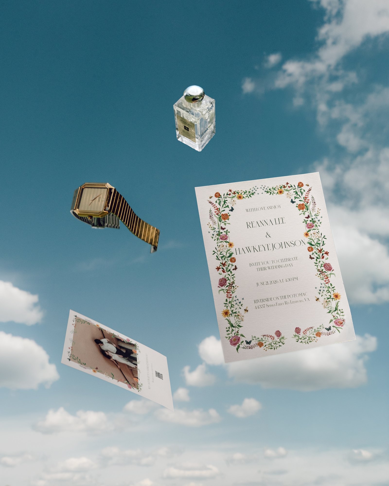 The wedding invitation suite thrown up against a blue sky, cards and envelope caught mid air