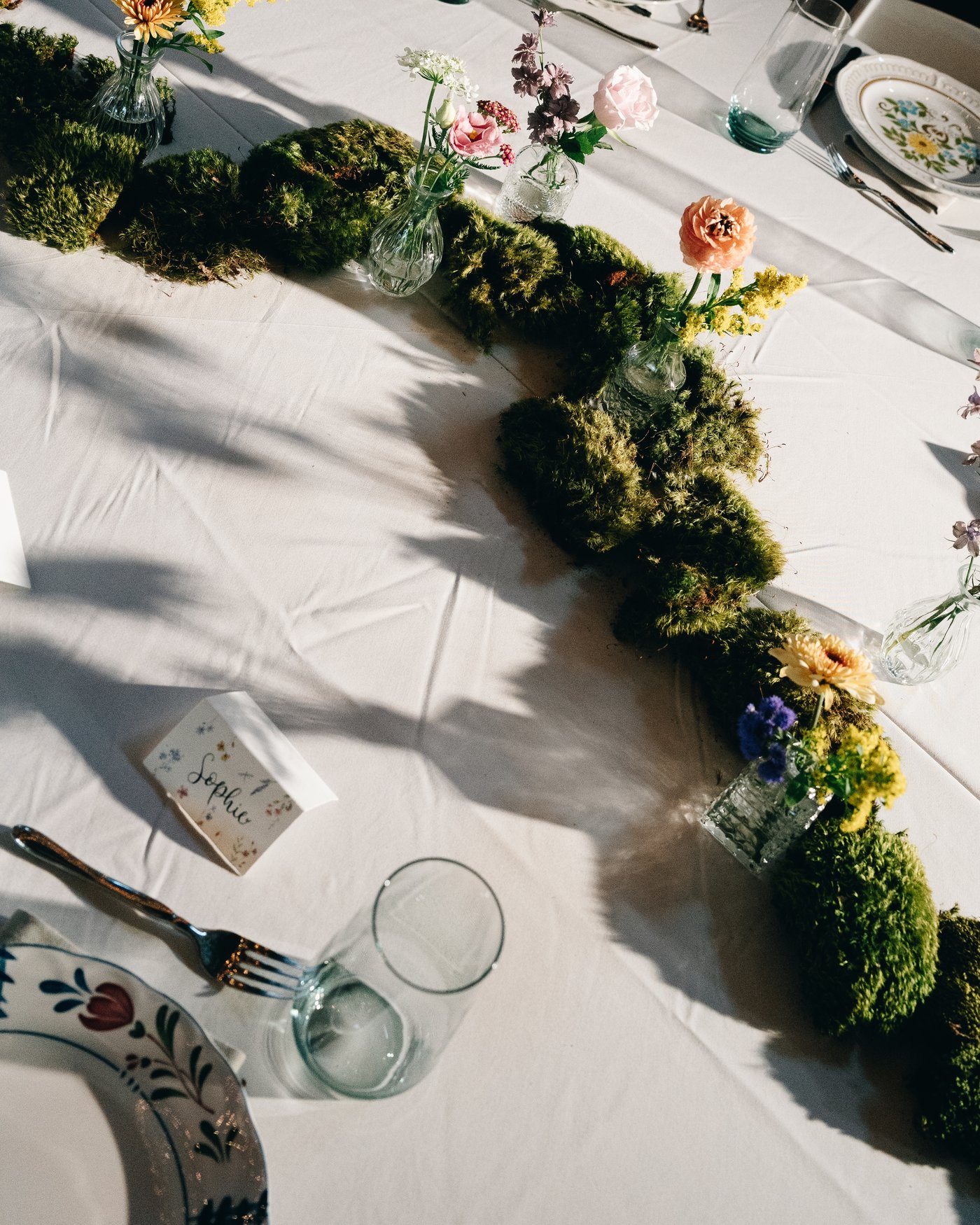 The ceremony arch dressed in flowers against a blue sky