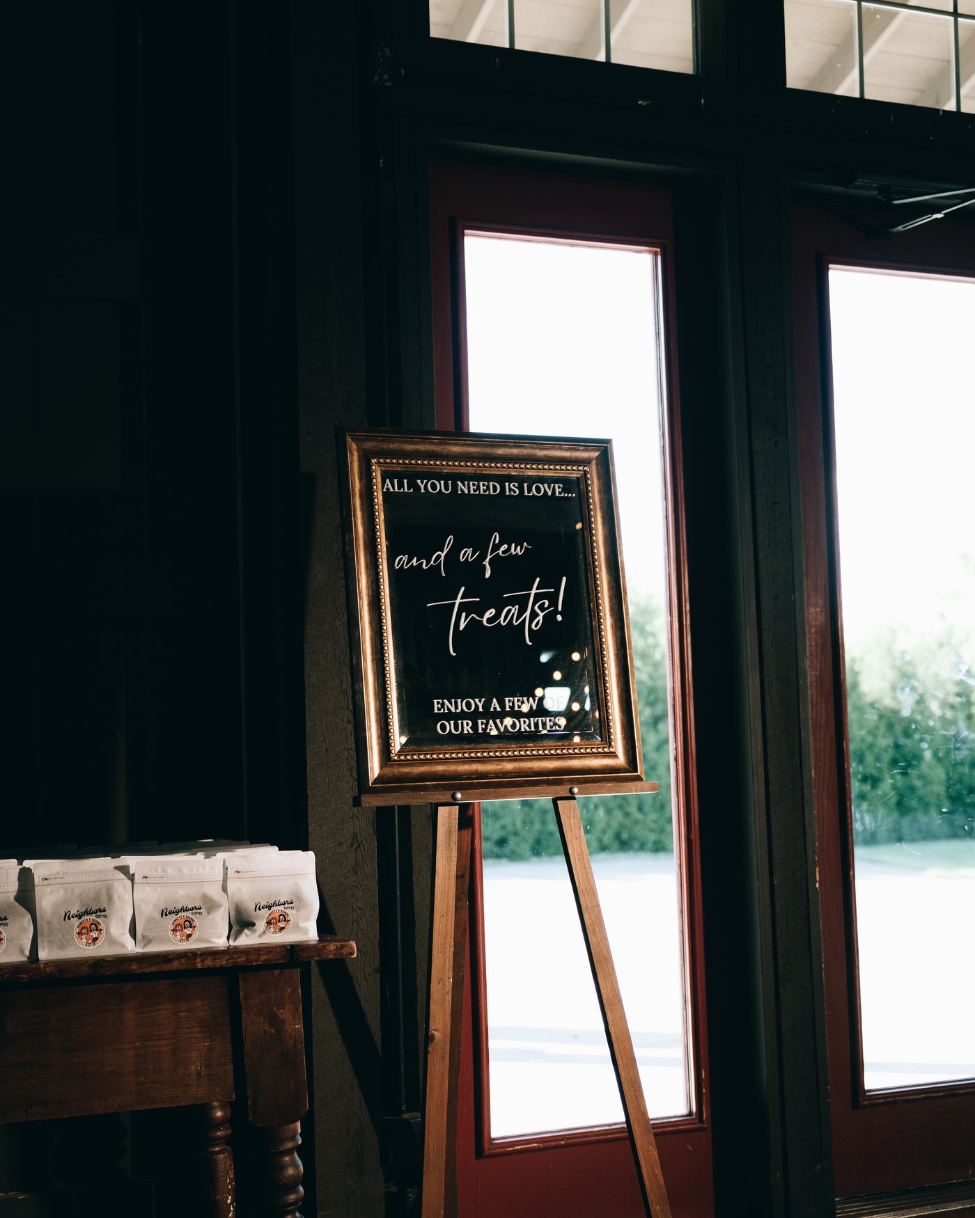 A hand lettered welcome sign on an easel beside the barn window