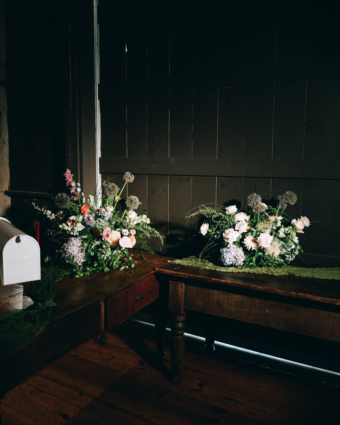 Wildflower arrangements running down a long dark table