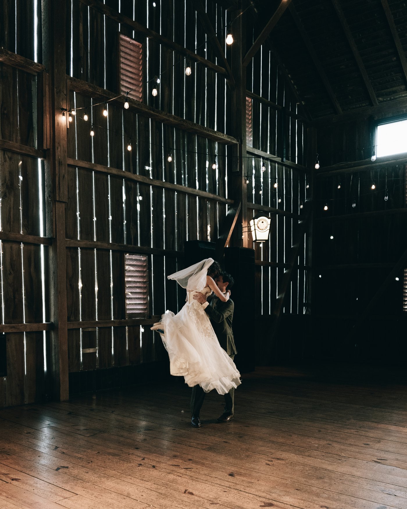 The bride spinning on the barn floor, her gown flying out
